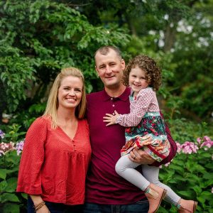 Man, woman and child in gardens. 