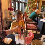 Kids at the craft tables in the Manor House living room