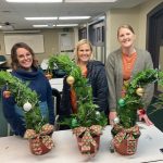 Three guests show off their Whoville inspired arrangements